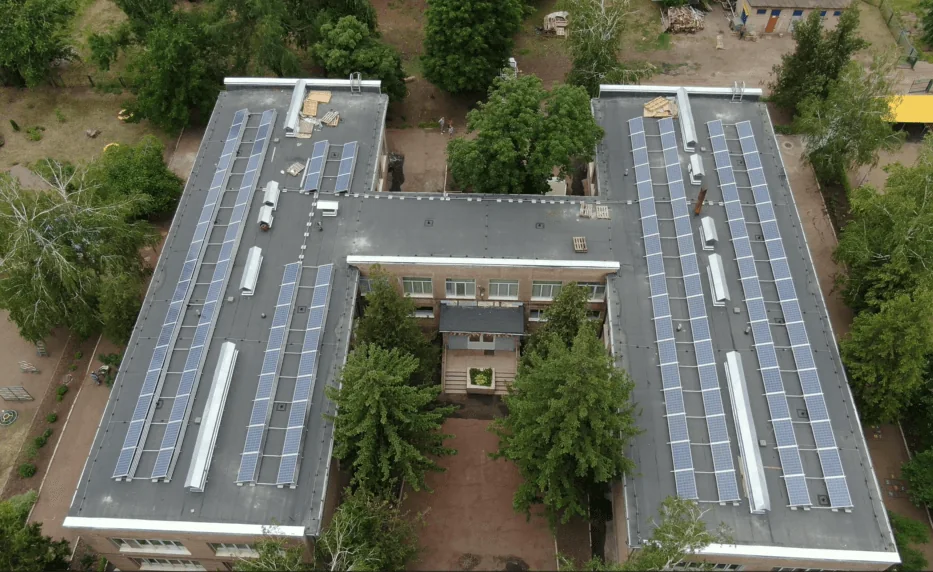 Editorial hero for “An ESCO Portfolio for Local Clean Energy”: infrastructure, people and the project’s core technical intervention, without implying that the project is complete.