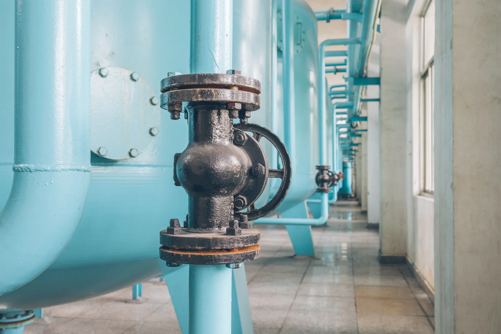 Editorial hero for “Right-Sized, Efficient Boiler Houses”: infrastructure, people and the project’s core technical intervention, without implying that the project is complete.